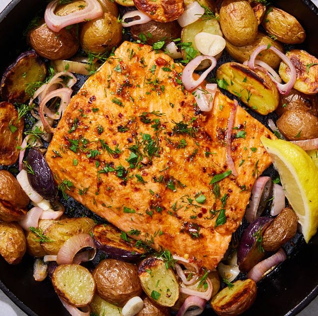 Salmon and Potato Skillet salmon with sliced potatoes in a skillet with sliced garlic and shallots