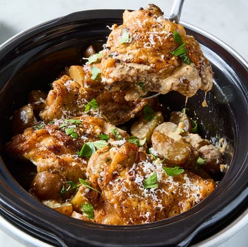 Slow-Cooker Garlic-Parmesan Chicken chicken thighs with potatoes, lemon, and parmesan in a slow cooker