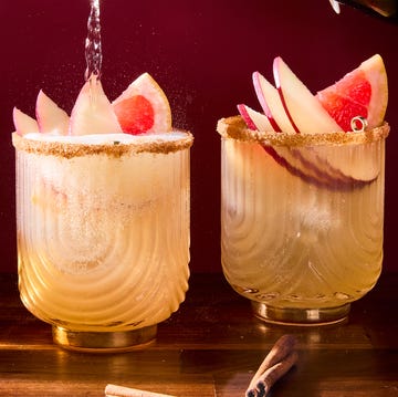 Spiced Apple Paloma - 2025 Drink Of The Fall spiced apple paloma cocktail garnished with slices of apples and a grapefruit wedge