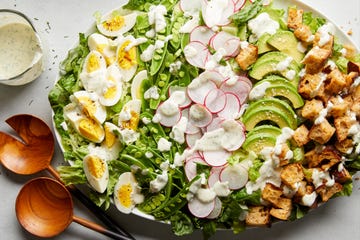 spring cobb salad with hard boiled eggs, spring peas, radishes, avocado, croutons, and dressing.