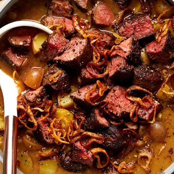 Steak Au Poivre Soup a bowl of creamy soup filled with steak, crispy onions ,and potatoes