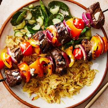 Steak Kebab Bowls steak kebabs in a bowl with orzo and cucumber spinach salad