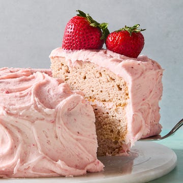 Strawberry Cake layered strawberry cake with pink icing and a strawberry on top