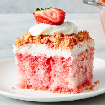 Strawberry Crunch Poke Cake strawberry crunch poke cake with a crumble topping, whipped cream and strawberries
