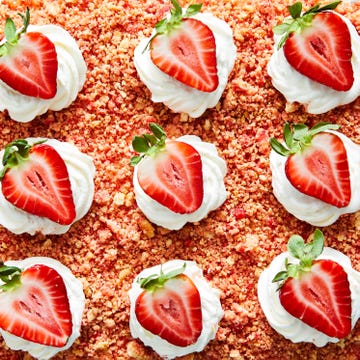 Strawberry Crunch Poke Cake strawberry crunch poke cake with a crumble topping, whipped cream and strawberries