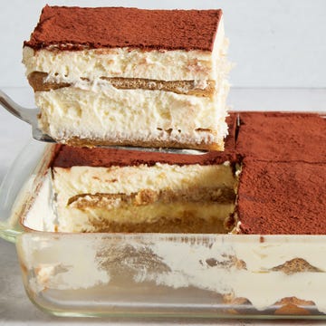 Tiramisu ladyfingers soaked in coffee layered with cream topped with a dusting of cocoa powder