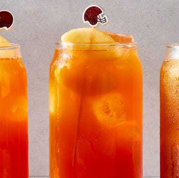 Touchdown Tea tea in a glass with a peach slice and mini football garnish