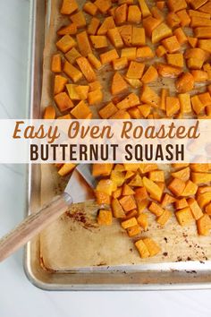 roasted butternut squash on a baking sheet with text overlay that reads easy oven roasted butternut squash