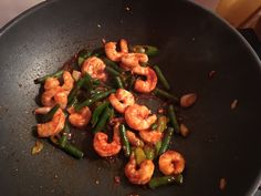 shrimp and green beans cooking in a wok