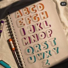 an open notebook with letters and numbers on it