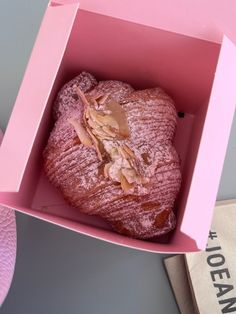a heart shaped pastry in a pink box