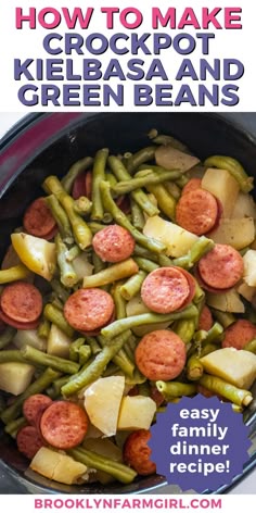 overhead shot of a black crock pot with a mix of sausage potatoes and green beans