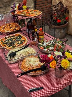 a table topped with lots of different types of pizzas and pies on top of it