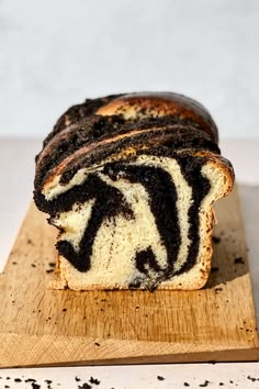 a loaf of zebra bread sitting on top of a wooden cutting board