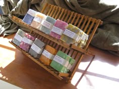 soaps are stacked on wooden racks in the sunlight