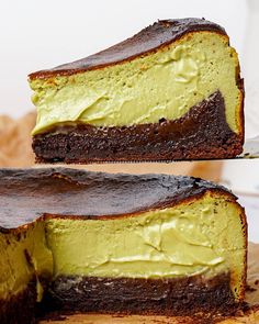 two slices of chocolate cake with green frosting on each slice and one piece cut out