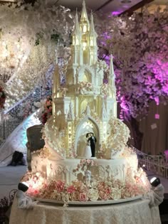 a wedding cake that looks like it has been made to look like disney's castle