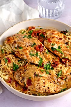 a white bowl filled with chicken and pasta