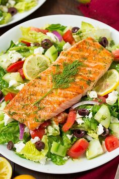 salmon and salad with olives, tomatoes, cucumber, lettuce
