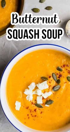a bowl of butternut squash soup with cheese and pumpkin seeds