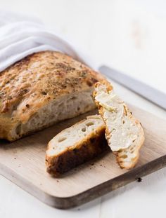a loaf of bread sitting on top of a cutting board