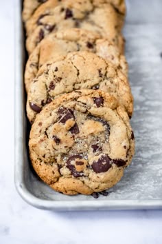 chocolate chip cookies sitting on top of a metal pan