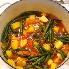 a pot filled with green beans and potatoes