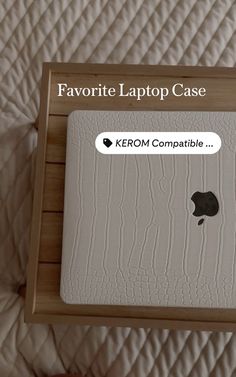 an apple laptop sitting on top of a bed with the text favorite laptop case next to it
