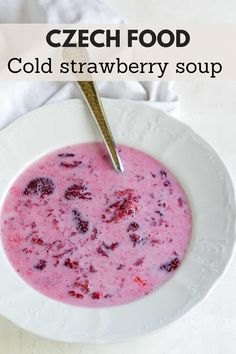 a close up of a bowl of soup on a table with a spoon in it
