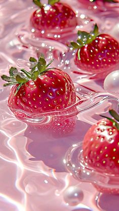 strawberries floating in water with pearls on the bottom