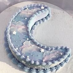 the cake is decorated with clouds and stars