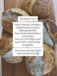 a bunch of breads sitting on top of a wooden table next to a piece of paper