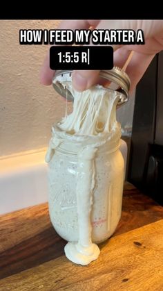someone is pouring something into a jar with the words, how i feed my starter