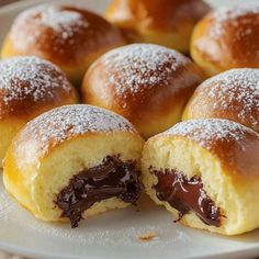 chocolate filled pastries on a plate with powdered sugar