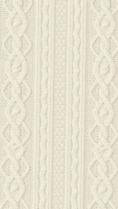 a white knitted wallpaper with an intricate design