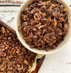 a bowl filled with granola sitting on top of a table