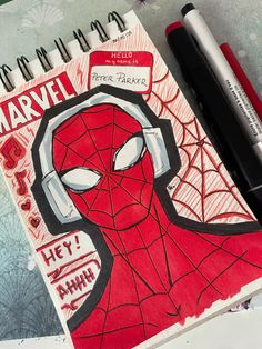 a drawing of a spider - man on a notebook