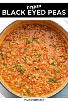 a pot filled with black eyed peas and garnished with parsley on the side