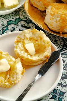there is a plate with biscuits and butter on it