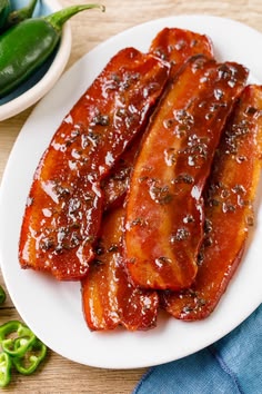 some food is on a white plate with green peppers in the backgroung