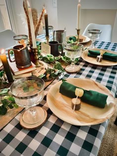 the table is set with green napkins and place settings