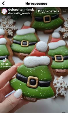 someone is holding some christmas cookies in their hand