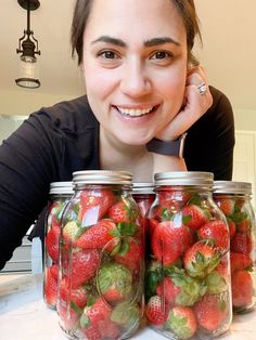 A Better Way to Store Strawberries for Extended Shelf Life - Kristin smiling over mason jars full of strawberries