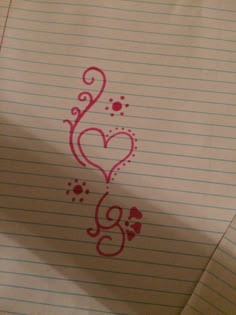 a piece of lined paper with writing on it and a heart drawn in the middle