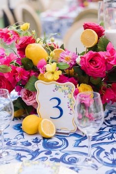 the table is decorated with flowers and lemons