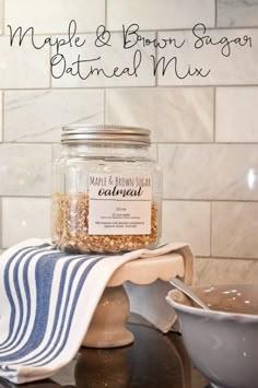 a jar of maple and brown sugar bath mix sitting on a towel next to a bowl of oatmeal