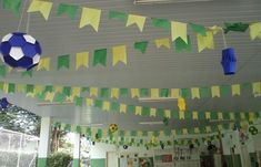 some paper decorations hanging from the ceiling in a school room with green and yellow streamers