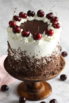 a black forest cake with cherries and chocolate shavings on the top is ready to be eaten