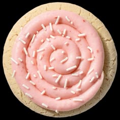 a cookie with pink icing and sprinkles