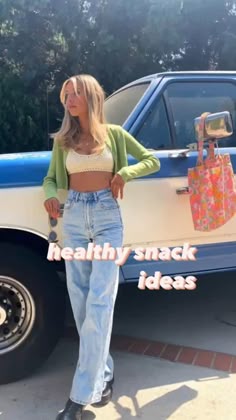 a woman standing in front of a car with a shopping bag on her hippie